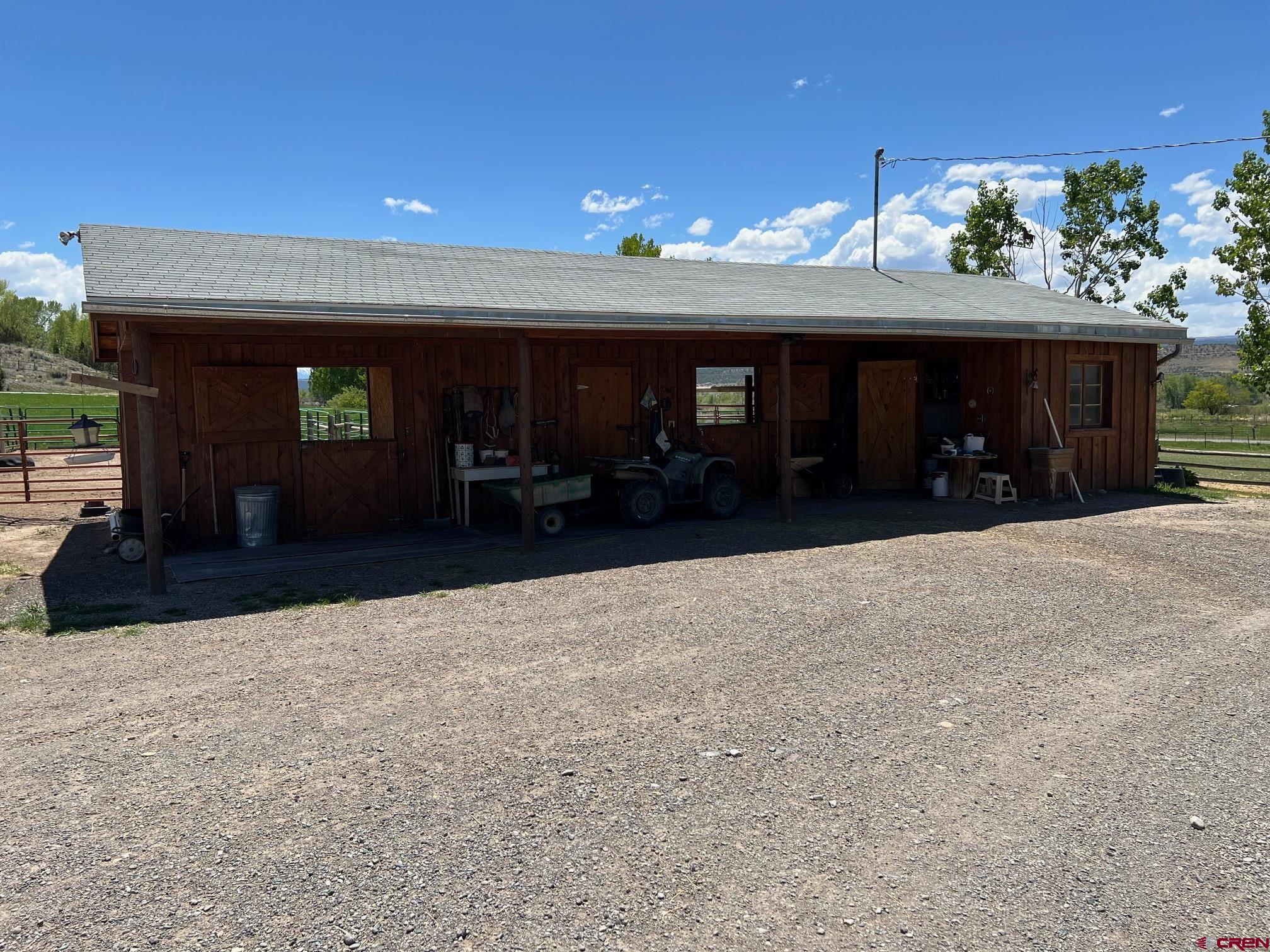 21446 Uncompahgre Road Montrose, CO 81403 - Photo 28 of 40 a view of a living room with a tv
