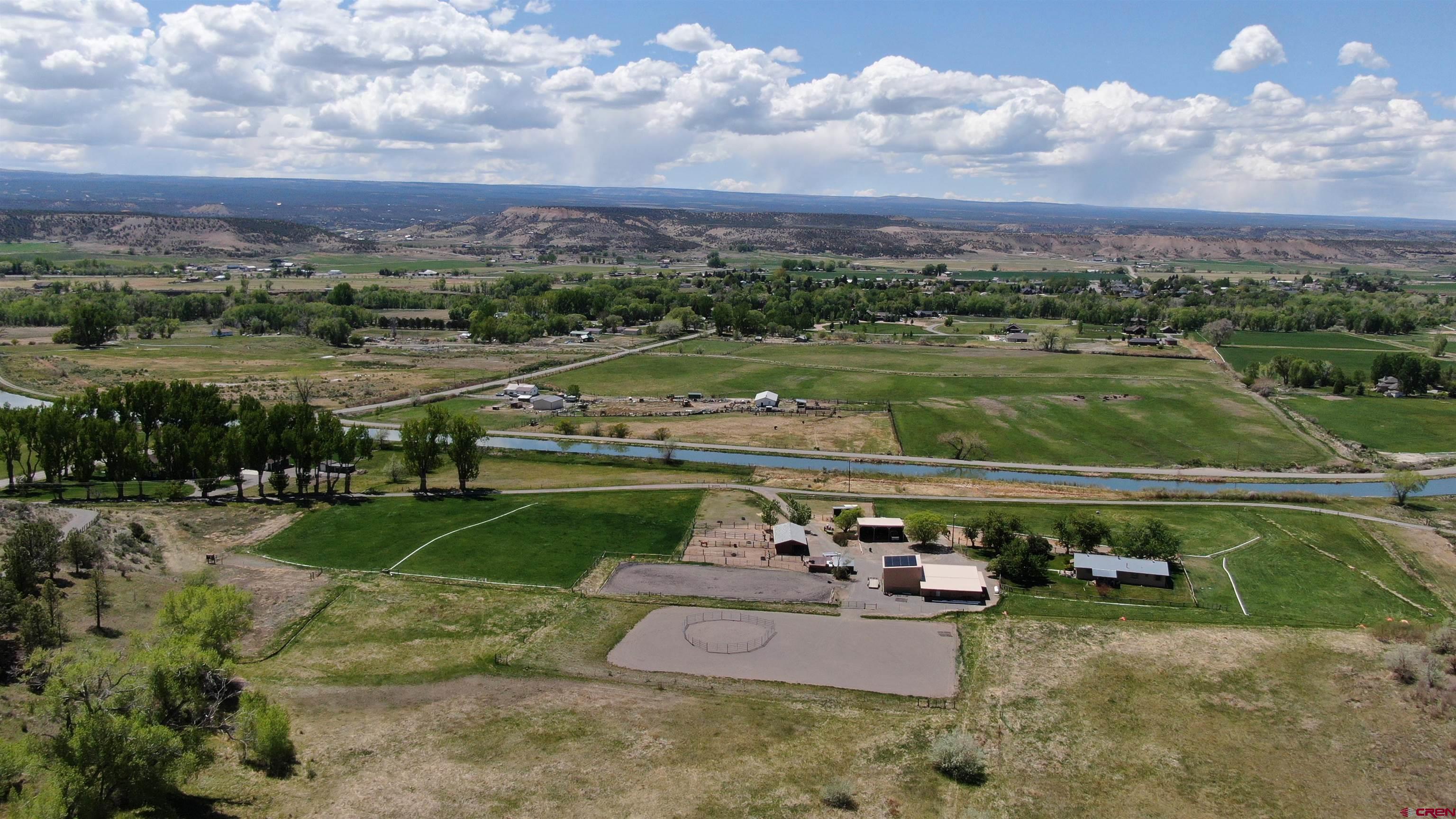 21446 Uncompahgre Road Montrose, CO 81403 - Photo 5 of 40 a view of a lake with a yard