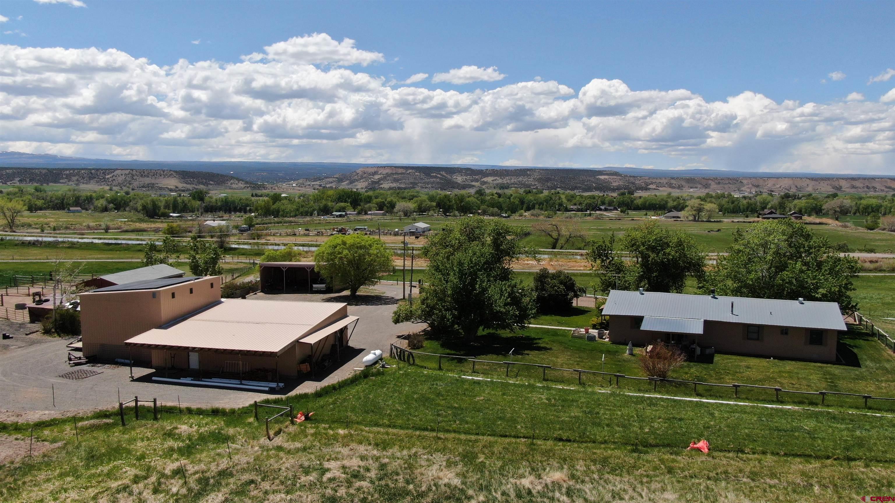 21446 Uncompahgre Road Montrose, CO 81403 - Photo 6 of 40 an aerial view of a house with outdoor space and lake view in back