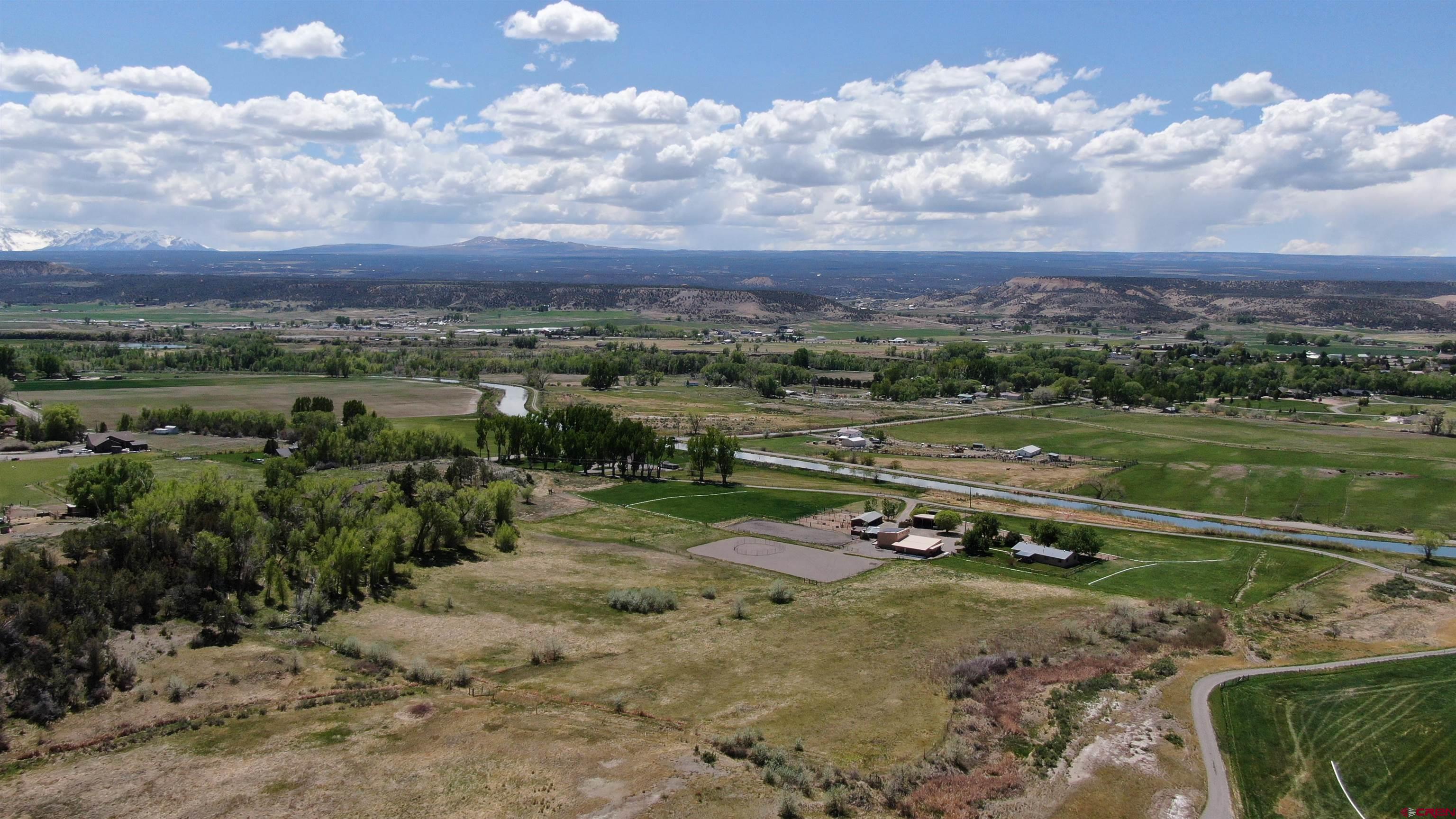 21446 Uncompahgre Road Montrose, CO 81403 - Photo 7 of 40 an aerial view of a yard with a lake view