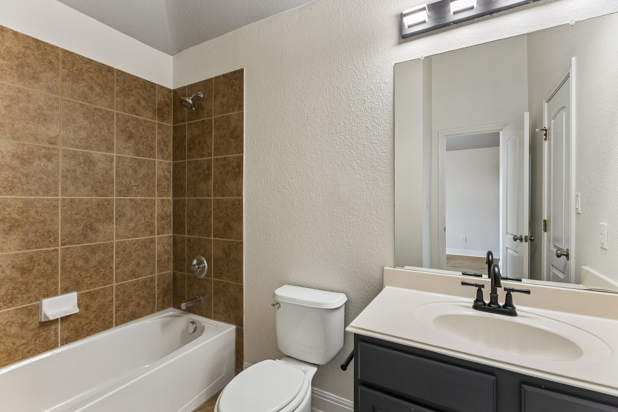 114 Aria Ridge, Unit 802 Lakeway, TX 78738 - Photo 19 of 37 A well-appointed bathroom with a spacious tub and shower, alongside a contemporary vanity.