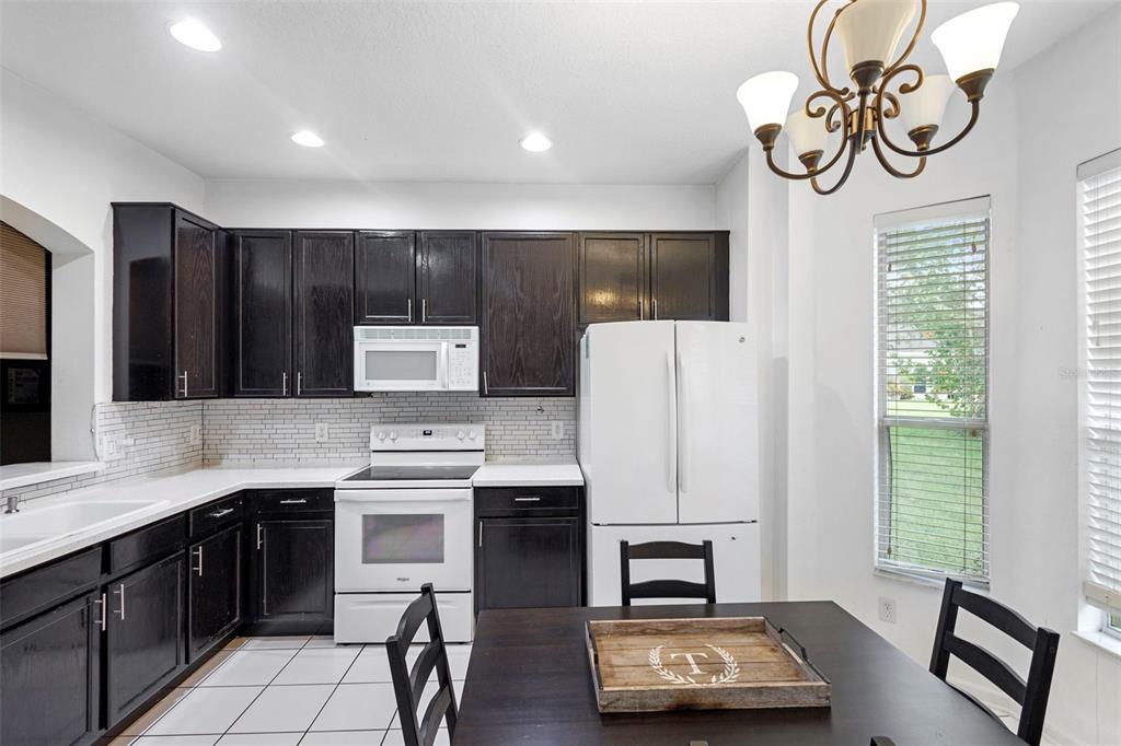 3111 River Branch Circle Kissimmee, FL 34741 - Photo 13 of 39 a kitchen with stainless steel appliances granite countertop a refrigerator sink and stove