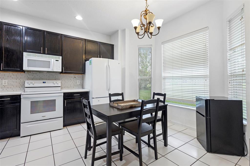 3111 River Branch Circle Kissimmee, FL 34741 - Photo 15 of 39 a kitchen with stainless steel appliances granite countertop white cabinets a sink and a stove