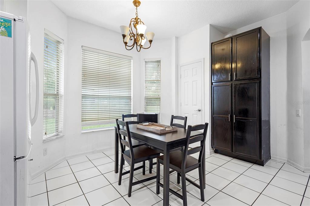 3111 River Branch Circle Kissimmee, FL 34741 - Photo 16 of 39 a view of a dining room with furniture and chandelier