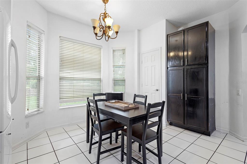 3111 River Branch Circle Kissimmee, FL 34741 - Photo 17 of 39 a view of a dining room with furniture and chandelier