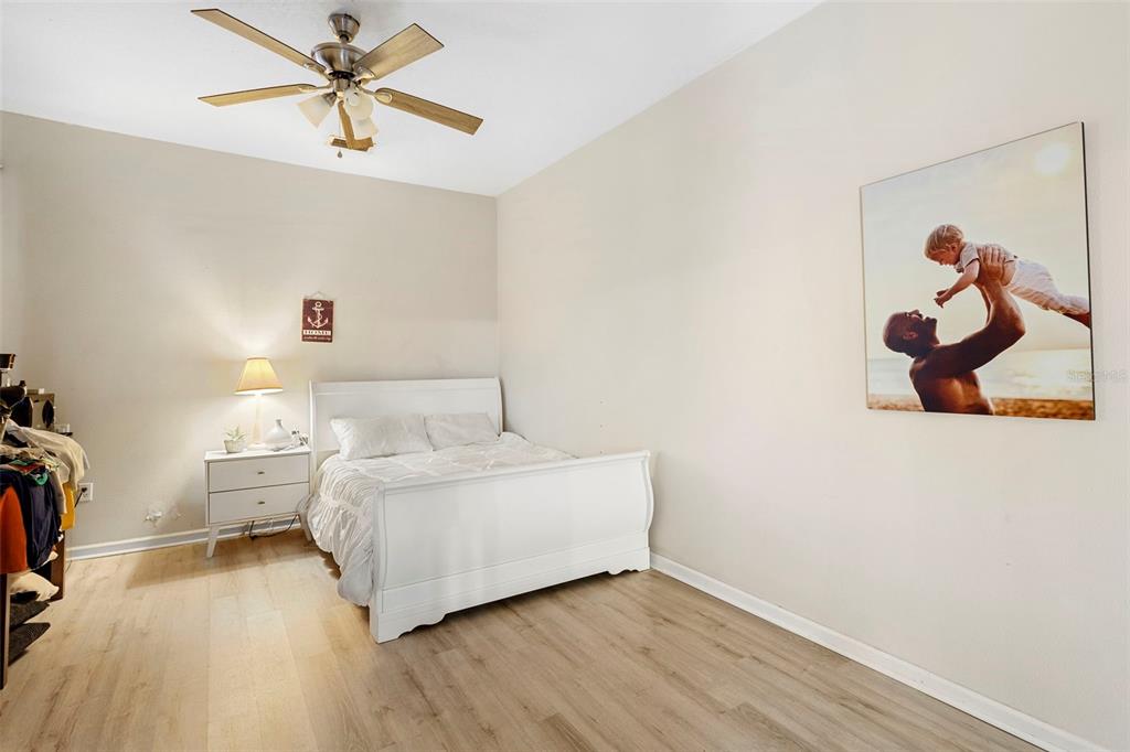 3111 River Branch Circle Kissimmee, FL 34741 - Photo 19 of 39 a room with a bed and a chandelier