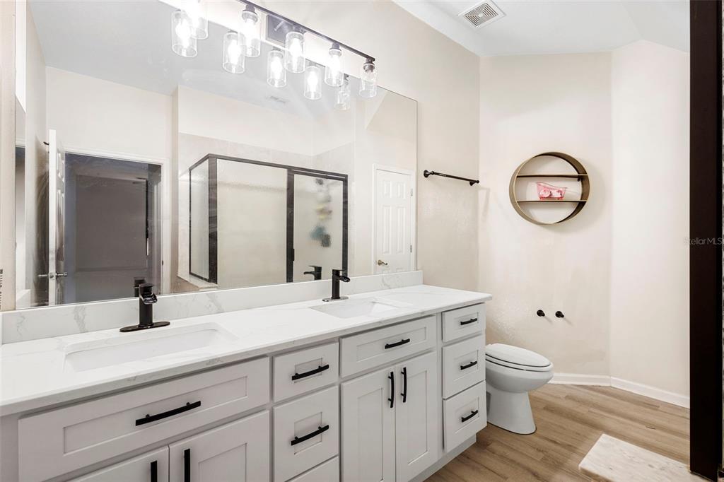3111 River Branch Circle Kissimmee, FL 34741 - Photo 21 of 39 a bathroom with a granite countertop sink mirror vanity and toilet