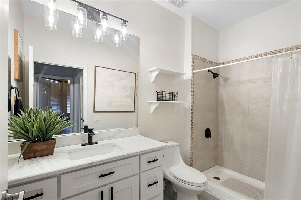 3111 River Branch Circle Kissimmee, FL 34741 - Photo 24 of 39 a bathroom with a sink a toilet a mirror and shower