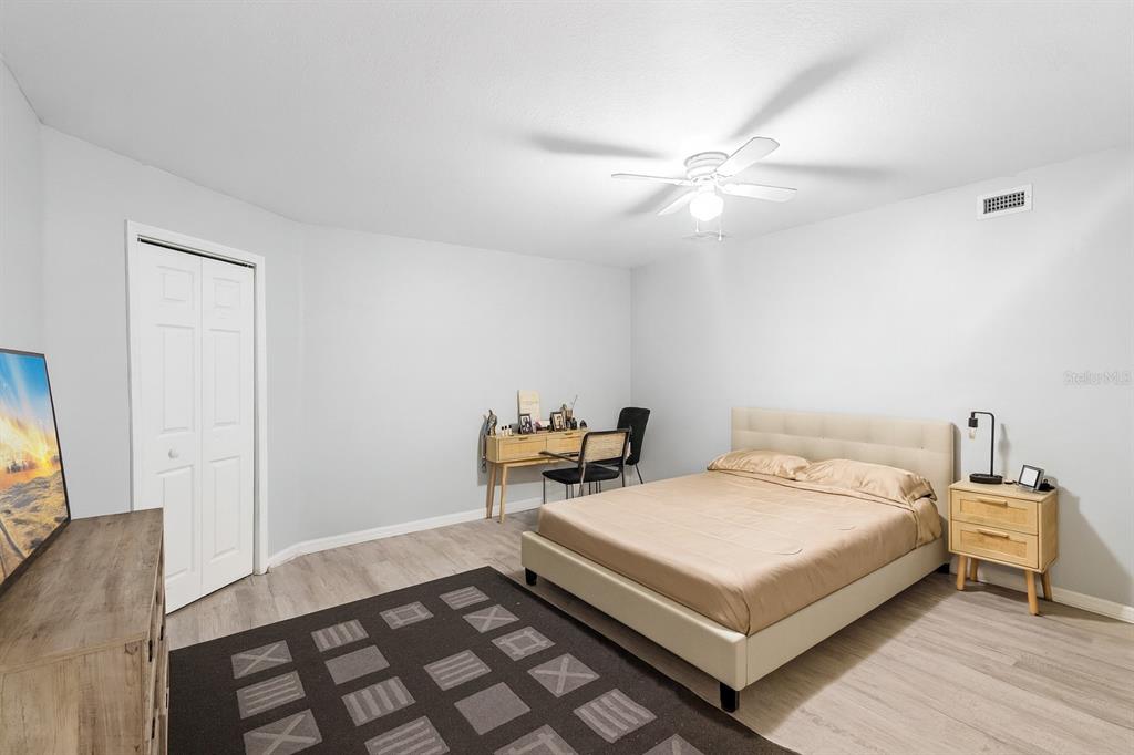 3111 River Branch Circle Kissimmee, FL 34741 - Photo 28 of 39 a bedroom with a bed and a chandelier