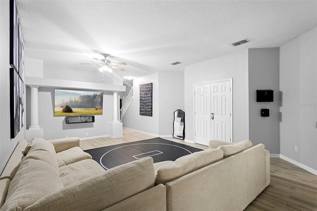 3111 River Branch Circle Kissimmee, FL 34741 - Photo 9 of 39 a living room with furniture and a flat screen tv