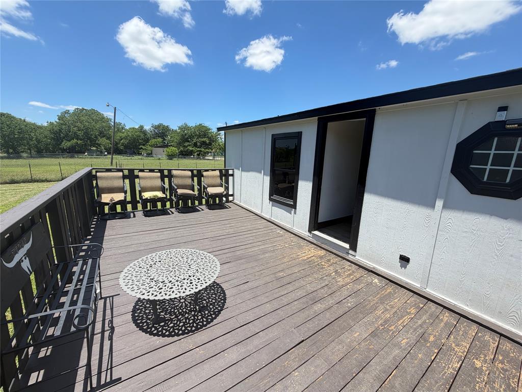 222 Hix Road Cleburne, TX 76031 - Photo 23 of 27 a roof deck with table and chairs