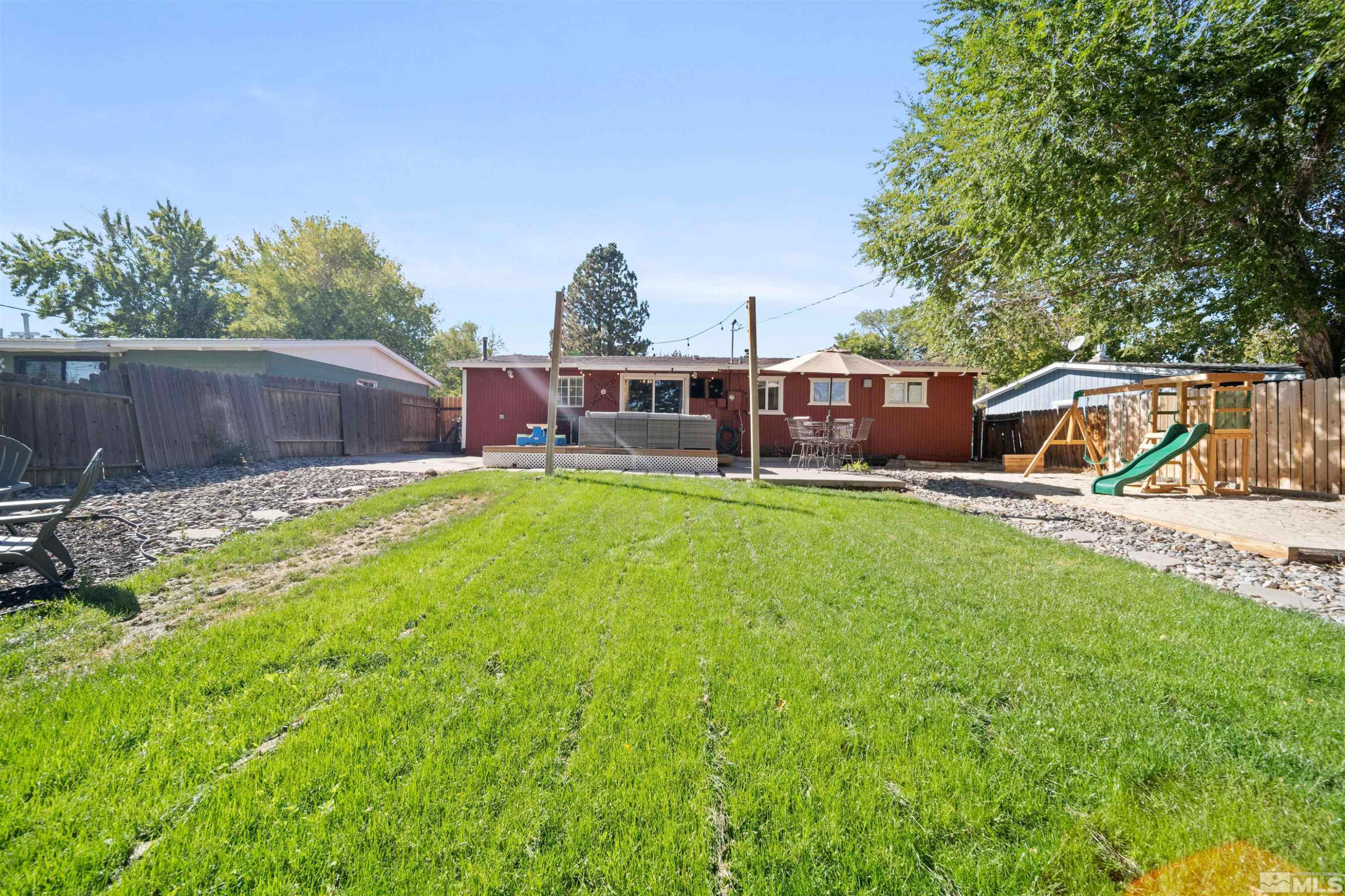 730 Stoker Avenue Reno, NV 89503 - Photo 29 of 32 a view of a house with a big yard and sitting area