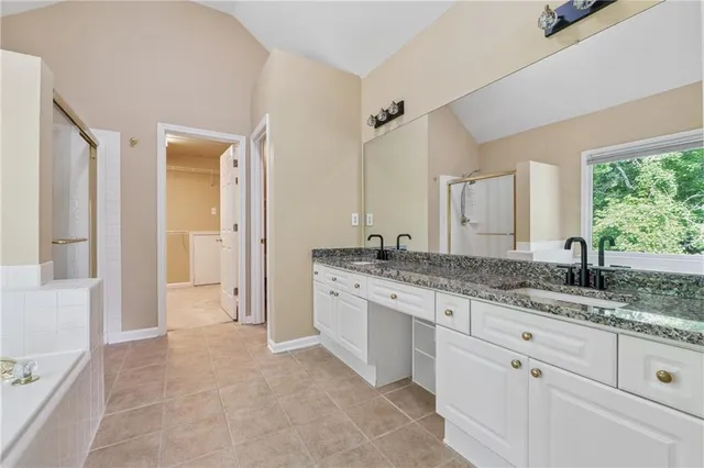 a spacious bathroom with a granite countertop sink mirror and a