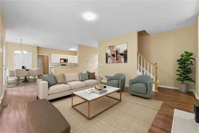 a living room with furniture or couch and a potted plant