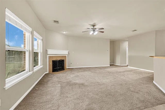 a view of an empty room with a fireplace