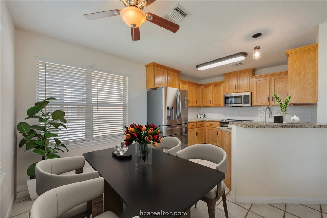 501 Riggs Street Brenham, TX 77833 - Photo 6 of 20 a dining room with furniture a potted plant and kitchen view