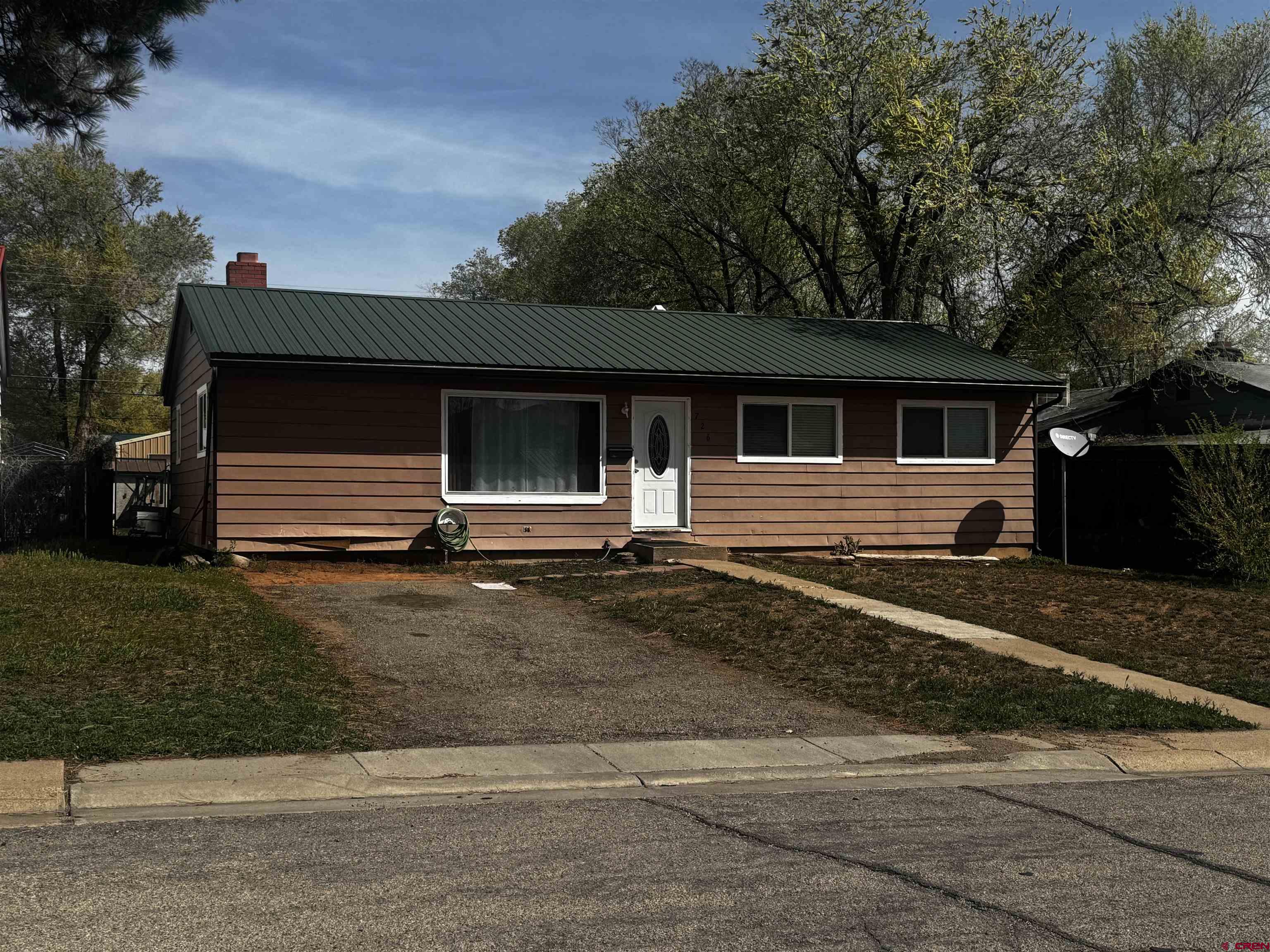 726 East 3rd Street Cortez, CO 81321 - Photo 1 of 20 a front view of a house with a yard