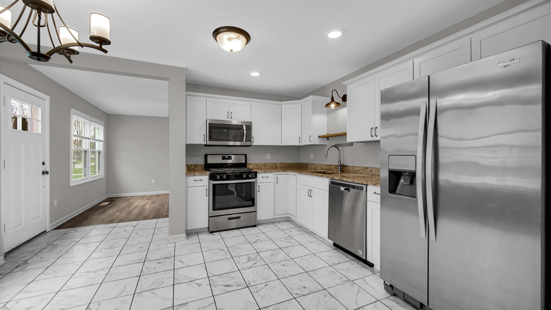 309 Michigami Trail Porter, IN 46304 - Photo 15 of 28 a kitchen with granite countertop a refrigerator and a stove top oven