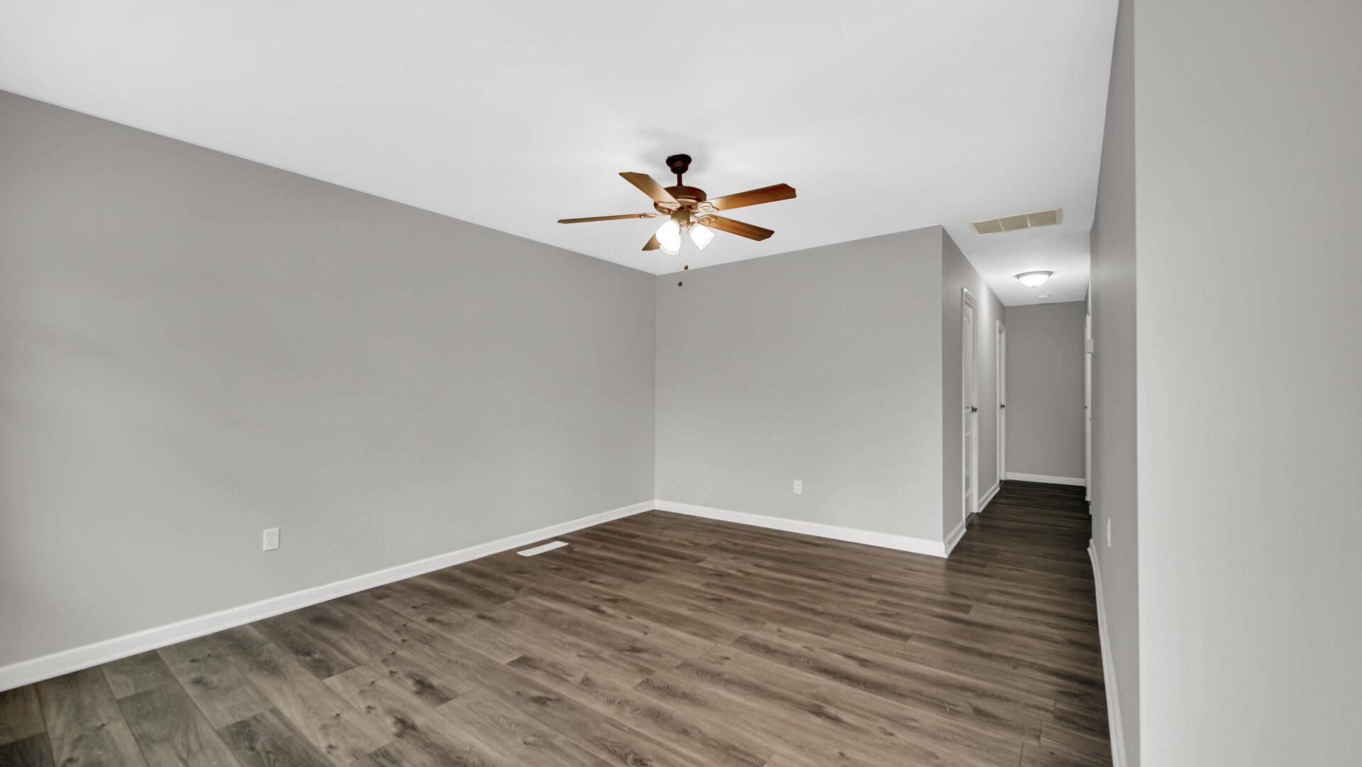 309 Michigami Trail Porter, IN 46304 - Photo 4 of 28 a view of an empty room with wooden floor and a ceiling fan