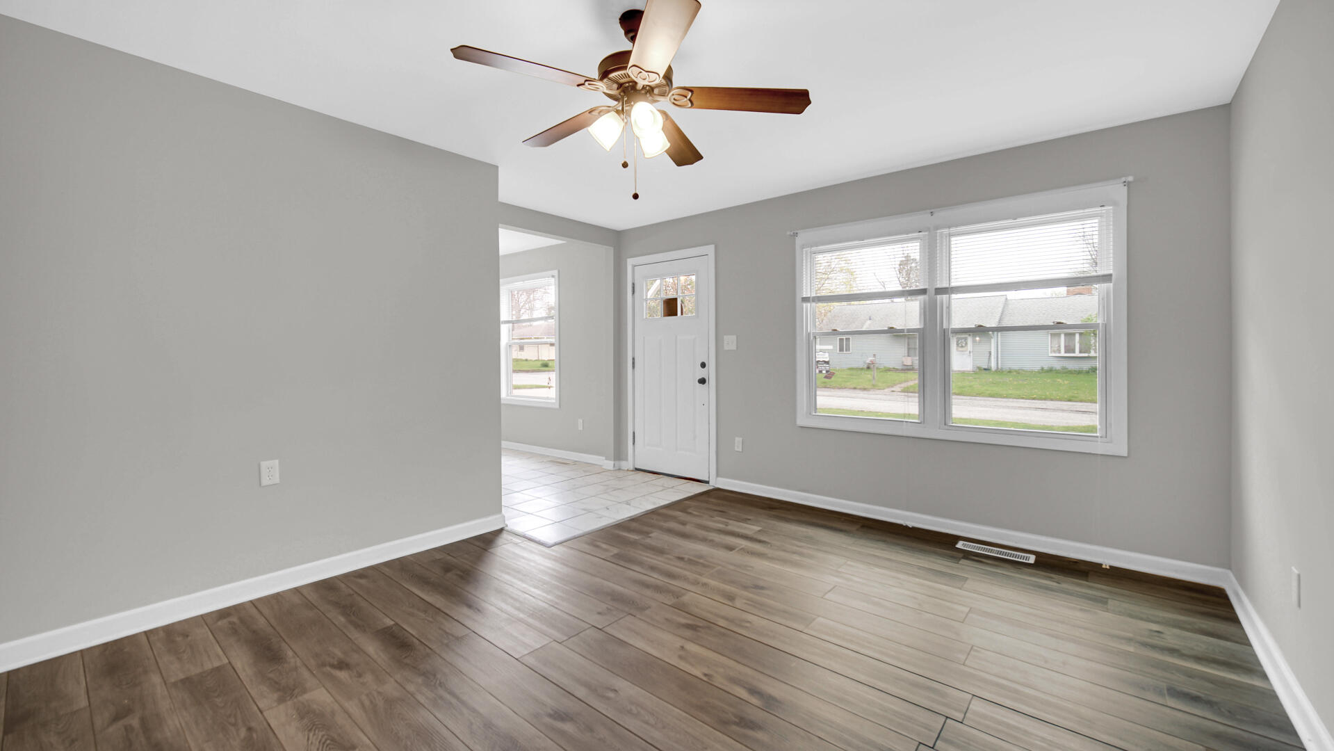 309 Michigami Trail Porter, IN 46304 - Photo 7 of 28 an empty room with wooden floor chandelier fan and windows