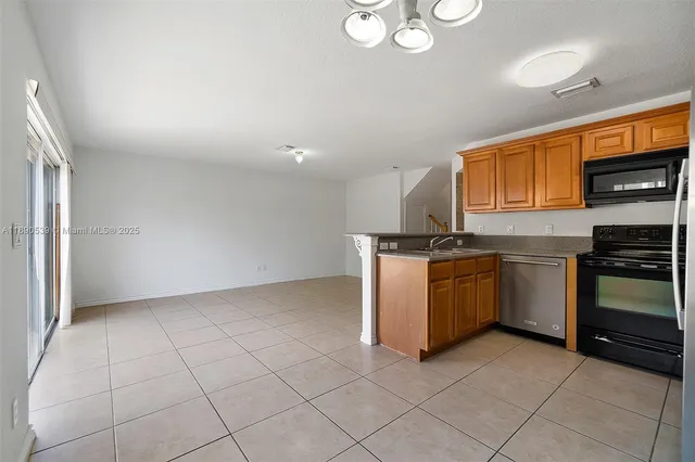 a kitchen with a stove top oven and cabinets