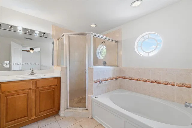 a bathroom with a bathtub a sink and a mirror