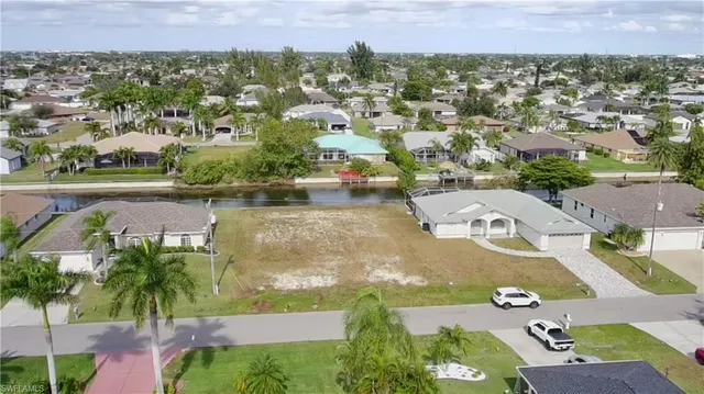an aerial view of residential houses with outdoor space and swimming pool