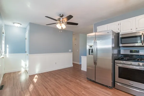 a kitchen with stainless steel appliances a refrigerator and a stove top oven
