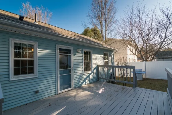 a view of backyard with a deck and wooden floor