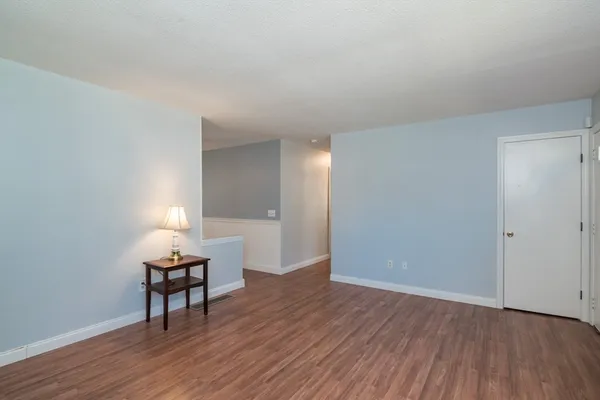 a view of room with hardwood floor and lounge chair