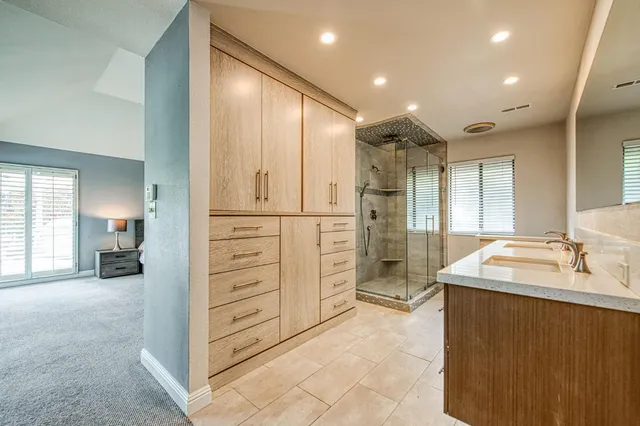 a bathroom with a sink a mirror and a shower