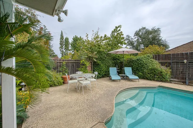 a view of backyard with outdoor seating and plants