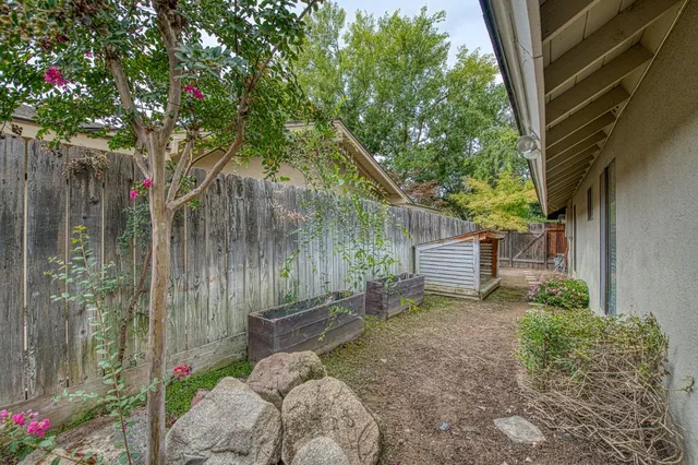 a backyard of a house with lots of green space and fountain