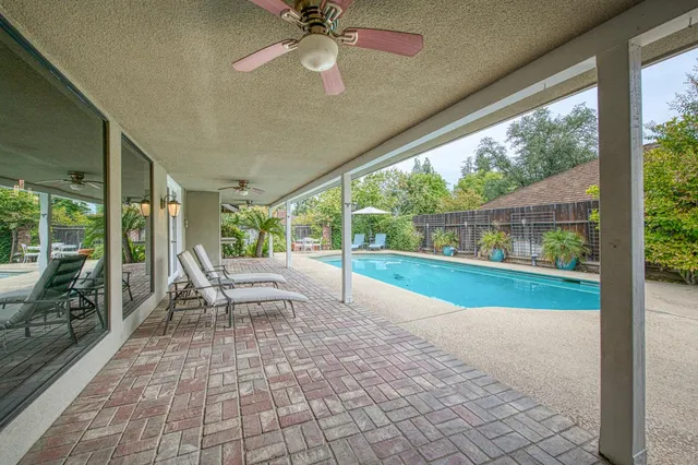 a view of a porch with chairs and backyard