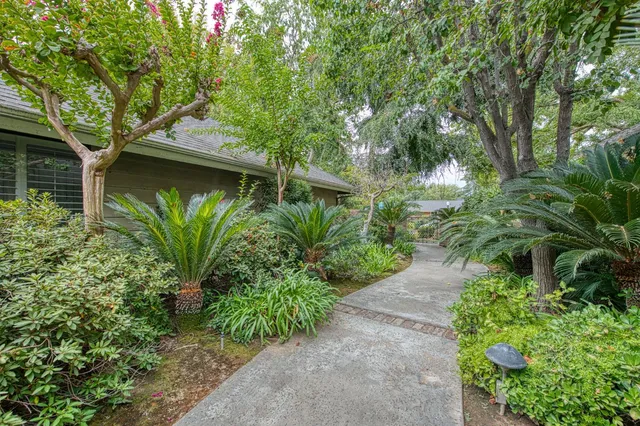 a yellow house with trees in front of it