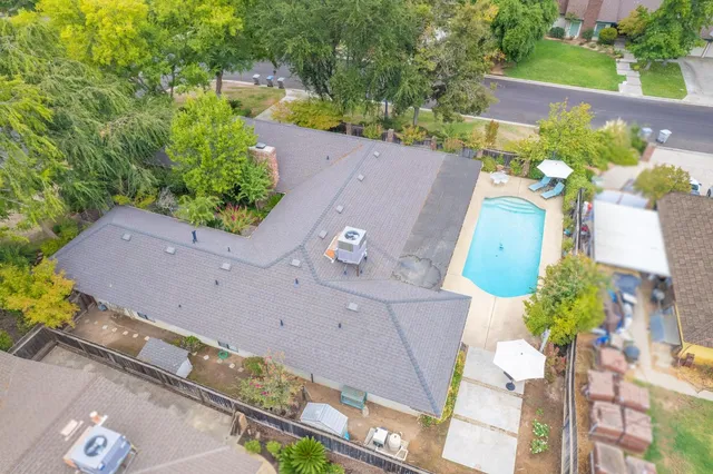 an aerial view of a house with a yard and a fountain