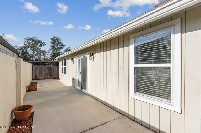 a view of a porch with a table and chairs