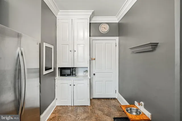 a kitchen with a refrigerator and microwave