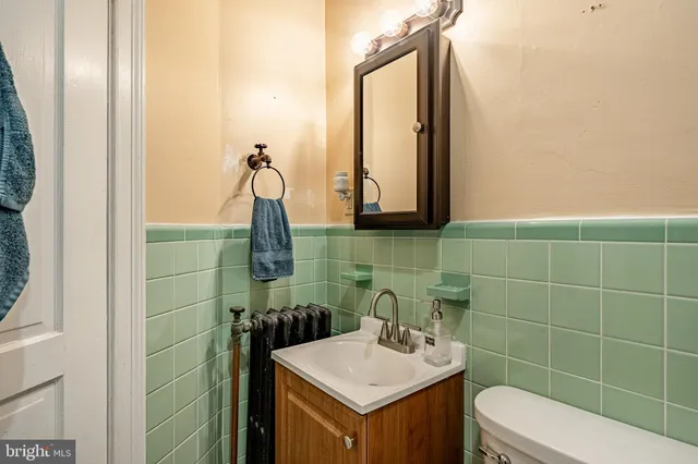 a bathroom with a sink a toilet and mirror