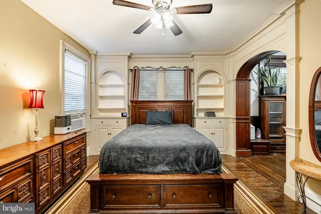 a bedroom with a bed and wooden floor