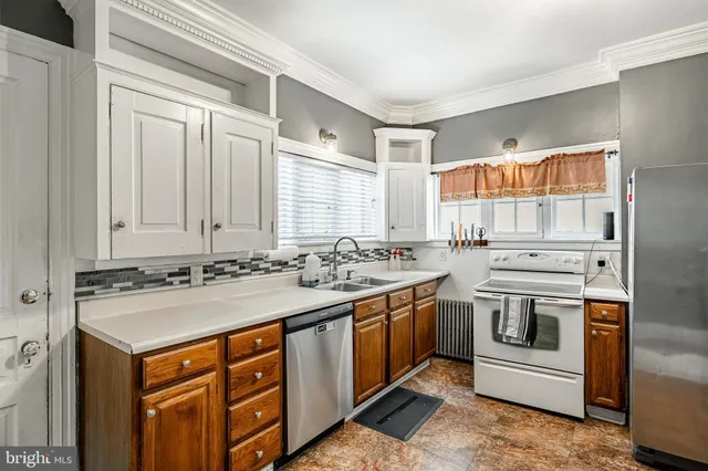 a kitchen with stainless steel appliances granite countertop a stove sink and cabinets