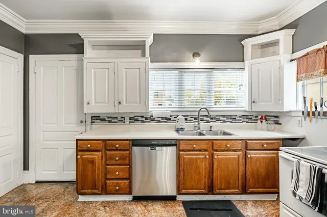 a kitchen with a sink stove and cabinets