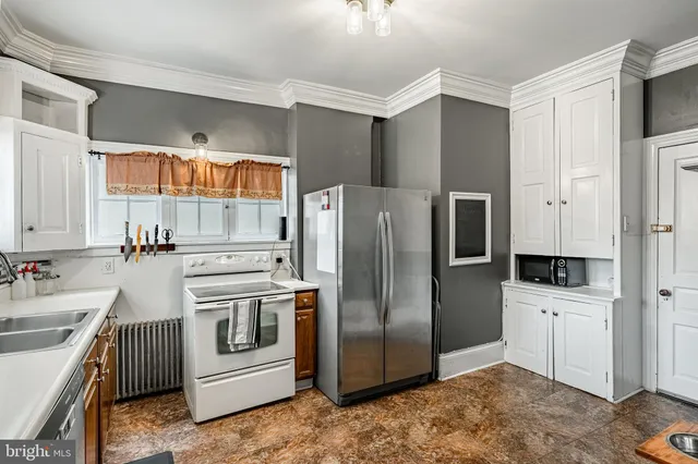 a kitchen with stainless steel appliances a refrigerator sink and stove