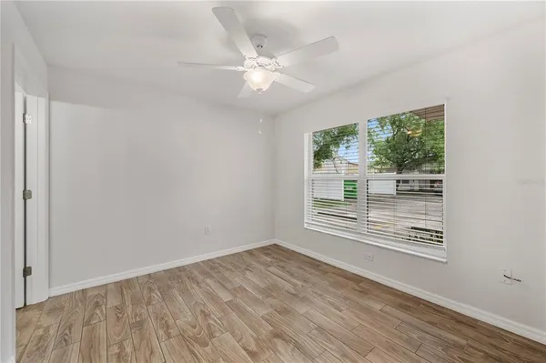 a view of an empty room with wooden floor