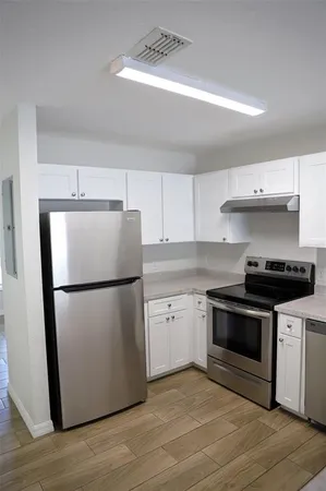 a view of a kitchen with a refrigerator a sink and dishwasher