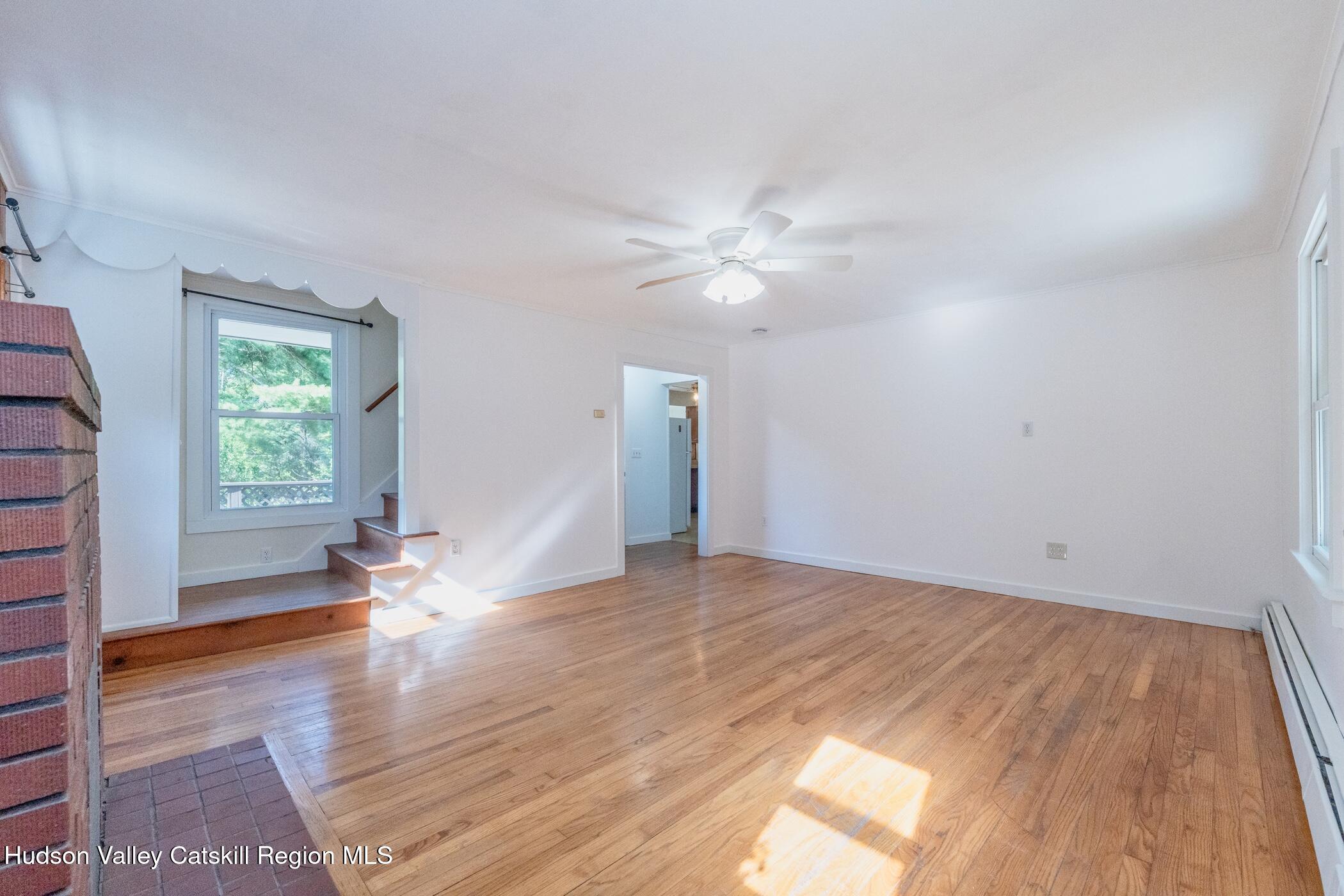 4533 Atwood Road Stone Ridge, NY 12484 - Photo 10 of 63 an empty room with wooden floor and window