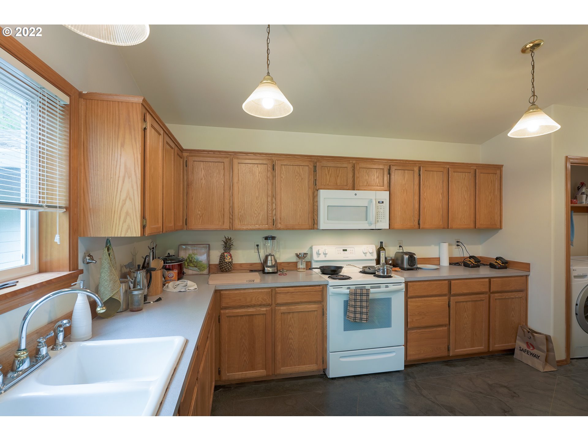 79774 Lower Nehalem Road Seaside, OR 97138 - Photo 13 of 32 a kitchen that has a sink cabinets counter space and appliances