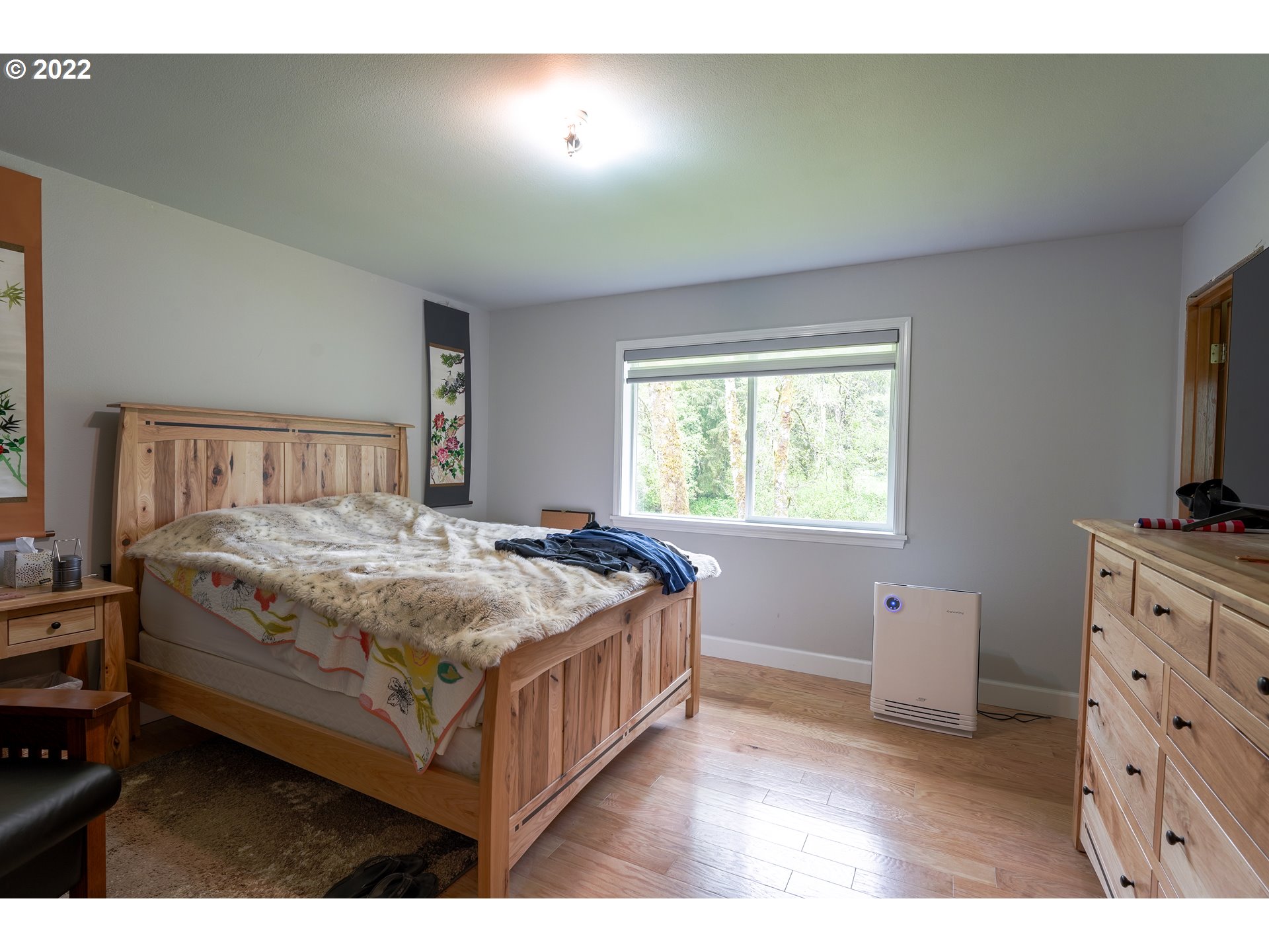79774 Lower Nehalem Road Seaside, OR 97138 - Photo 15 of 32 a bedroom with a bed and a flat tv screen on dresser