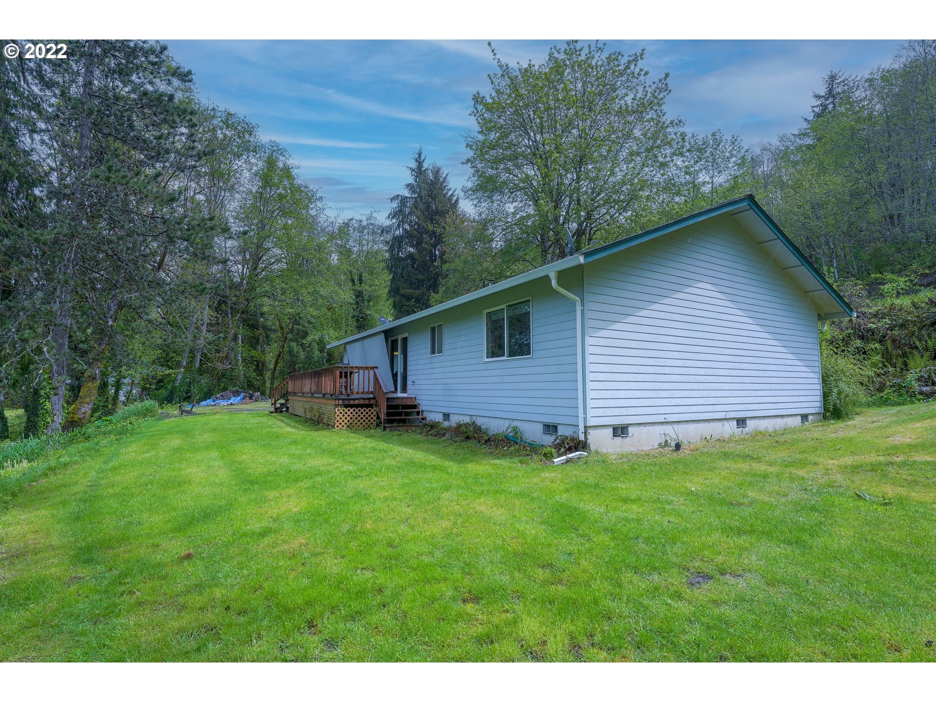 79774 Lower Nehalem Road Seaside, OR 97138 - Photo 23 of 32 a backyard of a house with lots of green space