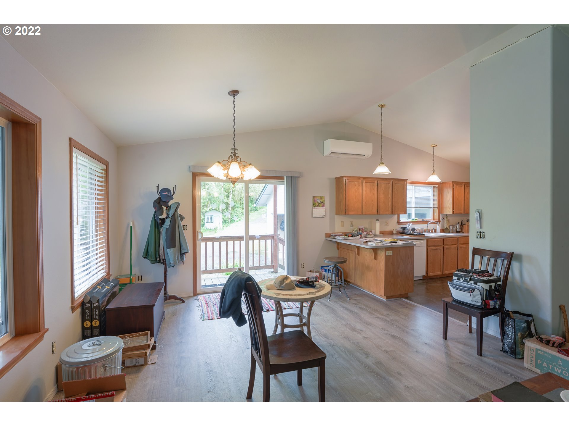 79774 Lower Nehalem Road Seaside, OR 97138 - Photo 10 of 32 a dining room with furniture a chandelier and wooden floor
